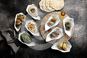 Assorted mix mezza with falafel, pita bread, salad, hummusm, served in a dish side of food set photo