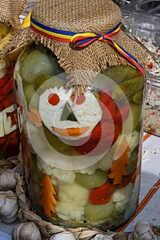 Assorted mix of pickles in sunlight during food festival. Pickled vegetables like red peppers