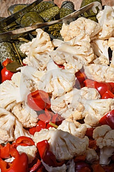 Assorted mix of pickles in sunlight during food festival. Pickled vegetables like red peppers