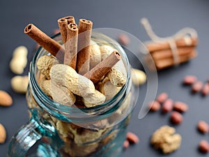 Assorted mixed nuts in a glass jar, peanuts, almonds, walnuts and sesame seeds