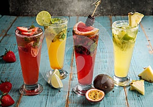 Assorted mojito or cocktail fish raw fruit, lemon slice, strawberry, passion fruit, orange served on glass isolated on cutting