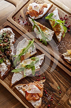 Assorted mouth-watering bruschettas on wooden boards. Close-up.