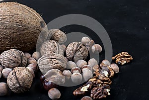 Assorted nuts on a black background