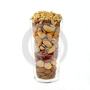 Assorted nuts in a glass cup on a white background
