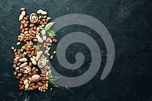 Assorted nuts on the old black background.