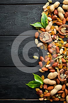 Assorted nuts on the old black background.