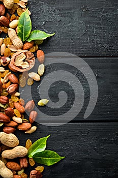 Assorted nuts on the old black background.
