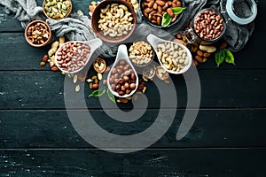 Assorted nuts on the old black background.