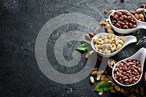 Assorted nuts on the old black background.