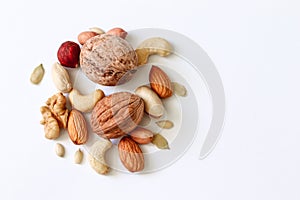 Assorted nuts on a white table. Hazelnuts, cashews, peanuts, walnuts, almonds.