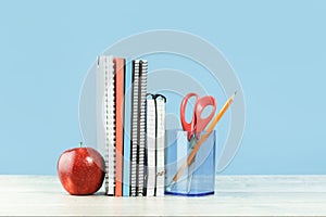 Assorted office and school orange and blue stationery with red apple