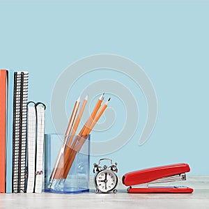 Assorted office and school orange and blue stationery with red apple
