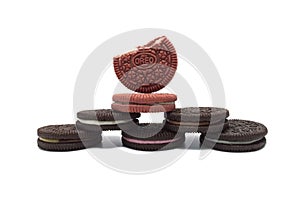 Assorted Oreo biscuits with cracked isolated on white background. Pile of sandwich cookies filled with cream flavored