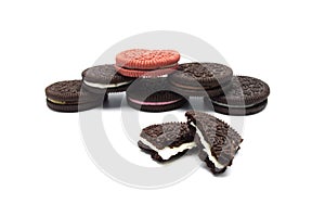 Assorted Oreo biscuits with cracked on white background. Pile of sandwich cookies filled with cream flavored