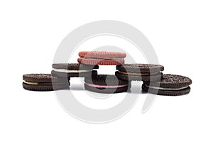 Assorted Oreo biscuits isolated on white background. Pile of sandwich cookies filled with cream flavored