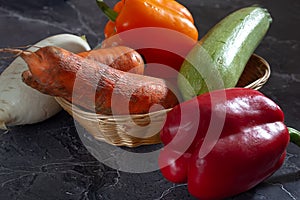 Assorted organic vegetables and fruits on a dark background