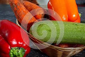 Assorted organic vegetables and fruits on a dark background