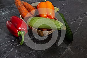 Assorted organic vegetables and fruits on a dark background