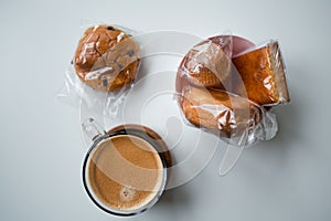 Assorted pastries and coffee on white background