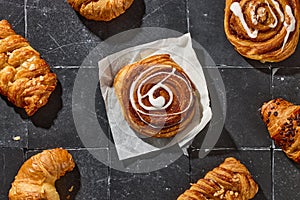 assorted pastries on dark grey old tiles background