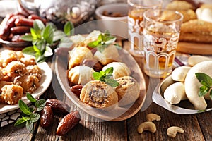 assorted of pastry, dried dates and mint tea