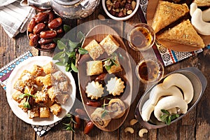 assorted of pastry, dried dates and mint tea