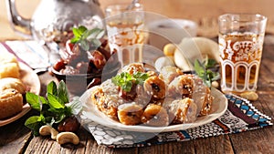 assorted of pastry, dried dates and mint tea