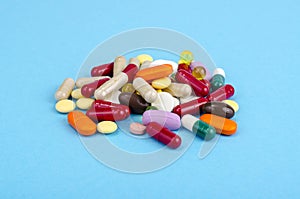 Assorted pharmaceutical medicine pills, tablets and capsules on bright background. Drugs and various narcotic substances