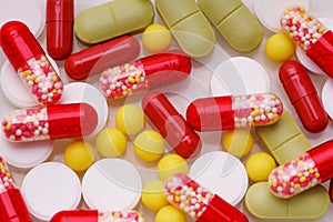 Assorted pharmaceutical medicine pills, tablets and capsules over white background