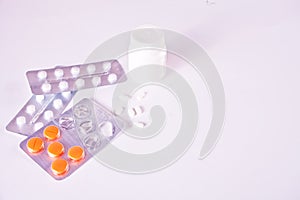 Assorted pharmaceutical medicine pills and tablets on the white background. Medical, pharmacy and healthcare concept. Copy space