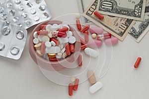 Assorted pharmaceutical pills, empty blister packs and dollar bills