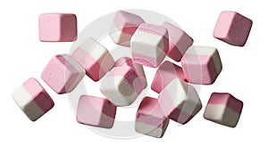Assorted pink and white marshmallow cubes scattered on a plain surface