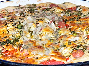 Assorted pizza background. Homemade vegetable pie. Open pie. Caloric nutrition. Pizza with tomatoes, cheese, herbs and eggs.