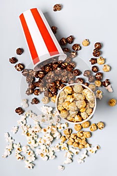 Assorted popcorn set in paper striped white red cup. Sweet and salty popcorn