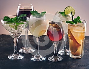 Assorted refreshing cocktails in various glasses isolated on white