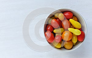 Assorted roasted and raw nuts scattered on white