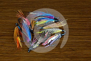 Assorted Salmon Fishing Flies on an Old Polished Table Top