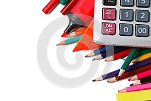 Assorted school supplies, including pens, pencils, scissors, glue and a ruler, on a white background