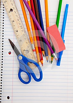 Assorted School Supplies on a lined notebook