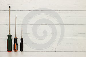 Assorted screwdrivers on white wooden background