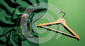 Assorted sewing tools on a fabric-covered surface. Large metal scissors, a thimble,