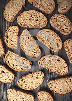 Assorted sliced artisan bread on wooden background