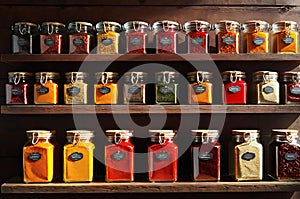 Assorted Spices in Translucent Glass Jars - Backlight Enhancing Translucence, Arranged on a Rustic Wooden Surface photo