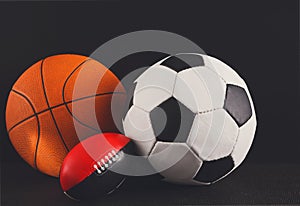 Assorted sport balls on black background