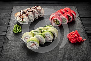 Assorted sushi nigiri and maki big set on slate. A variety of Japanese sushi with tuna, crab, salmon, eel and rolls