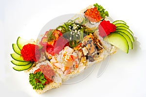 Assorted sushi roll with sesame seeds, cucumber, tobiko, chuka salad, eel, tuna, shrimp, salmon