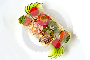 Assorted sushi roll with sesame seeds, cucumber, tobiko, chuka salad, eel, tuna, shrimp, salmon