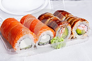 Assorted Sushi Rolls in a Takeout Container