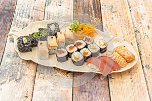 Assorted sushi tray with pieces of flambÃ©ed salmon nigiri, red tuna,