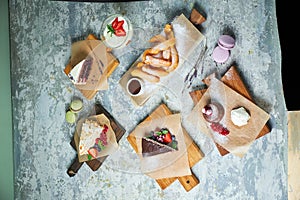 Assorted sweet desserts. Top view. Gray textured background. Beautiful serving dishes. Dessert. Food chain